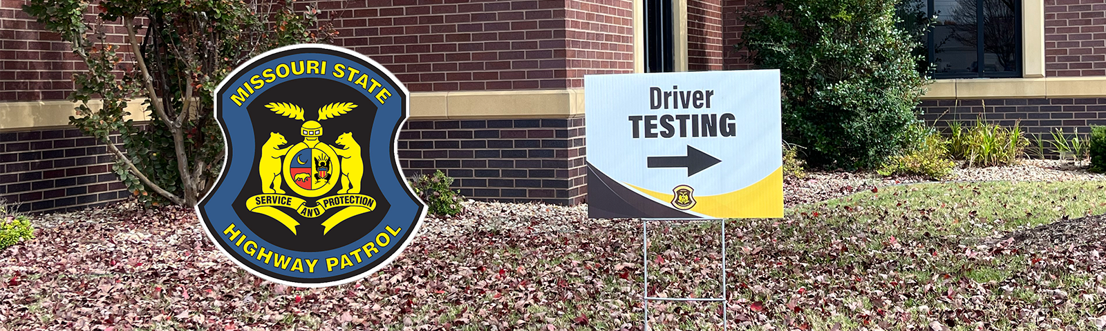 A sign indicates a driver testing site is to the right. The Missouri State Highway Patrol logo is superimposed next to the sign.